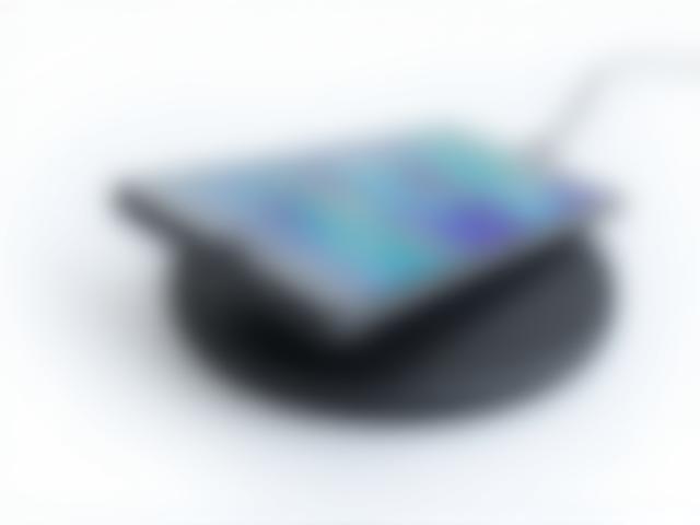 Fast wireless charger with sleek black finish shown with Samsung phone